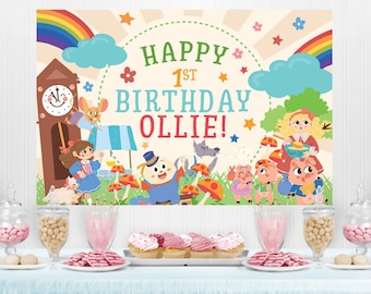 May include: A colorful birthday banner with a rainbow, clouds, stars, and a clock tower. The banner says "Happy 1st Birthday Ollie!" and features cartoon characters from the story of the Three Little Pigs.