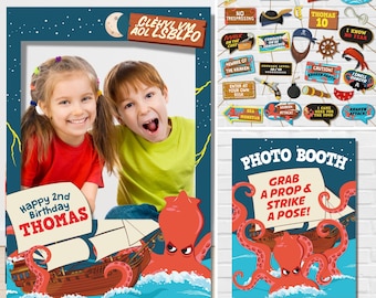 May include: A photo booth kit with pirate-themed props. Includes a frame with a ship and octopus illustration, and various signs with phrases like "Happy Birthday Thomas," "Kraken Attack!" and "Grab a Prop & Strike a Pose!"