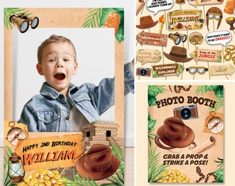 May include: Jungle-themed photo booth props for a birthday party. The props include a hat, binoculars, a camera, a compass, a snake, and signs with phrases like "Wild & Untamed" and "King of the Jungle".
