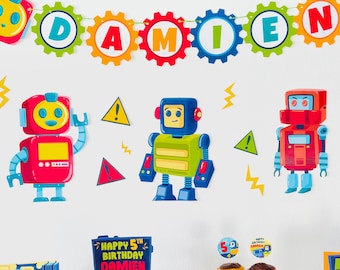 May include: A robot-themed birthday party decoration set with a banner that says "Damien" and includes robot cutouts, cupcake toppers, and a cake with a robot theme. The cake is decorated with chocolate frosting and robot figurines.