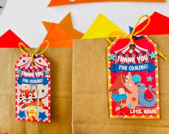 May include: Two brown paper gift bags with colourful circus-themed gift tags. The tags feature a tiger, a bear, and a seal, and the text "Thank you for coming!"  The tags are tied with yellow string.
