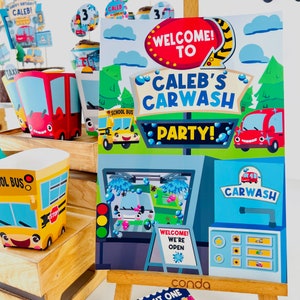 A blue and green car wash party sign with the text "Welcome to Caleb's Carwash Party!"  The sign features a cartoon car, a school bus, green garbage truck and a car wash station.