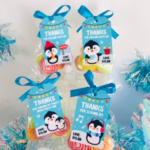 May include: Four blue and white favor tags with penguin illustrations and the text "Thanks for chilling with me!" and "Thanks for making my party snow much fun!" and "Thanks for sliding by!" and "Love. Dylan".