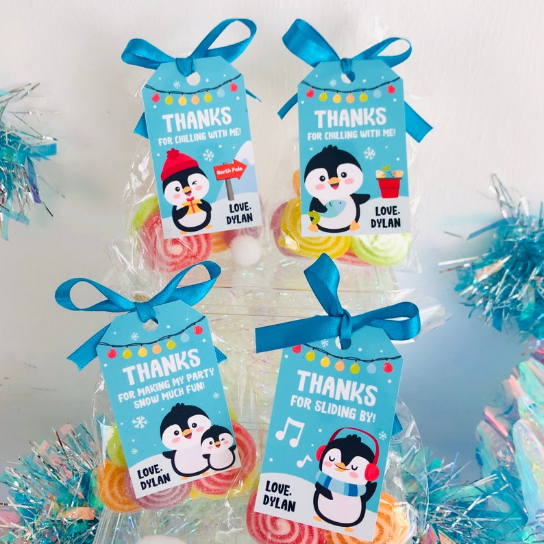 May include: Four blue and white favor tags with penguin illustrations and the text "Thanks for chilling with me!" and "Thanks for making my party snow much fun!" and "Thanks for sliding by!" and "Love. Dylan".
