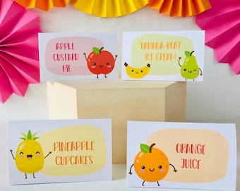 May include: Four printable food labels with cute fruit illustrations and text. The labels read "Apple Custard Pie", "Banana-Boat Ice Cream", "Pineapple Cupcakes", and "Orange Juice".