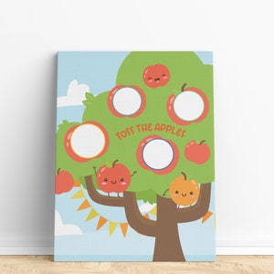 May include: A printable game for kids featuring a cartoon apple tree with red apples and a smiling orange. The text "Toss the Apples" is written on the tree.