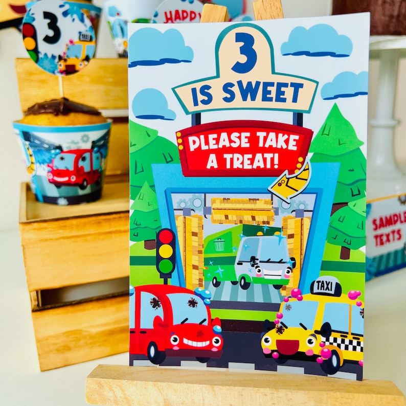 A colourful birthday party sign with a cartoon car wash party theme. The sign says "3 is sweet, please take a treat!" and features a red car, a yellow taxi and a green garbage truck.