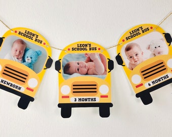 May include: A yellow school bus themed baby milestone banner with photos of a baby at different ages. The banner includes the text "Leon's School Bus" and the ages "Newborn", "3 Months", and "6 Months".