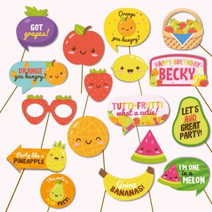 May include: A set of 14 colorful fruit-themed photo booth props. The props include a pineapple, watermelon, avocado, pear, lemon, orange, strawberry, apple, grapes, and bananas. The props are perfect for a fruit-themed party or event.