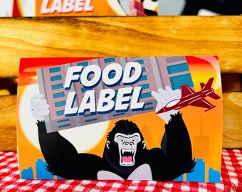 May include: A red and white food label with the text "FOOD LABEL" in black letters. The label features a cartoon gorilla holding a sign with the same text. The background is a cityscape with a red and white airplane flying in the sky.