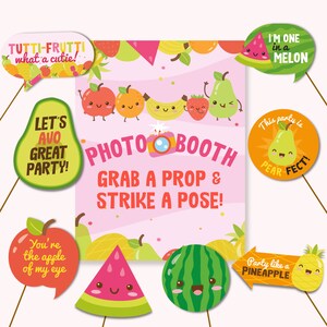 May include: A set of 10 photo booth props featuring various fruits with cute faces. The props include a watermelon, pineapple, pear, apple, and more. The text on the props includes phrases like "Let's Avo Great Party!" and "Party Like a Pineapple".
