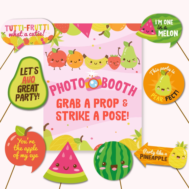 May include: A set of 10 photo booth props featuring various fruits with cute faces. The props include a watermelon, pineapple, pear, apple, and more. The text on the props includes phrases like "Let's Avo Great Party!" and "Party Like a Pineapple".
