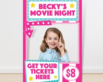 May include: Pink and blue movie night photo booth prop with a white and pink striped background. The prop has a cutout for a face and says "Becky's Movie Night" at the top. The bottom says "Get Your Tickets Here" with a star on either side and "$8" in a circle.