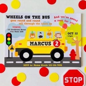 May include: A yellow school bus with the name "MARCUS" and the number "2" on the side. The bus is surrounded by a stop sign, a fire hydrant, and a traffic light. The text "WHEELS ON THE BUS goes round and round all through the town as" is at the top of the invitation. The text "And we've saved a seat for you!" is on the right side of the invitation. The text "WHEN: OCT 12 3-5pm" is on the right side of the invitation. The text "VENUE: 123 Henderson Street City State 1234" is on the left side of the invitation. The text "RSVP to: Mama Nicole 123-456-7890" is at the bottom of the invitation.