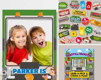 May include: A green and gray photo booth backdrop featuring a cartoon garbage truck with the text "Parker is 3". The backdrop includes props such as a garbage truck driver hat, a trash can, and a stop sign. The backdrop is designed for a birthday party.
