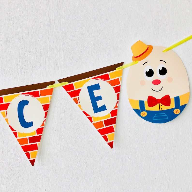 May include: A red and yellow brick pattern banner with the letters "C" and "E" in blue circles. A cartoon character with a yellow hat, red bow tie, and blue overalls is attached to the banner.