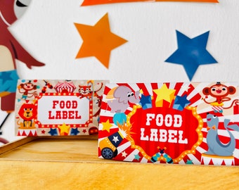 May include: Two red and white circus-themed food labels with the text "Food Label" in a white circle. The labels feature a variety of circus animals, including an elephant, a monkey, and a lion.