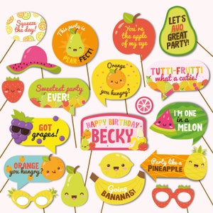 May include: A set of 15 colorful fruit-themed photo booth props with fun sayings like "Squeeze the day!" and "Going Bananas!" Perfect for a fruit-themed party.