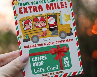 May include: A Christmas-themed gift card with a yellow school bus carrying elves and Santa Claus. The card reads "THANK YOU FOR GOING THE EXTRA MILE!" and "WISHING YOU A JOLLY CHRISTMAS!" A green gift card for a coffee shop is also featured.