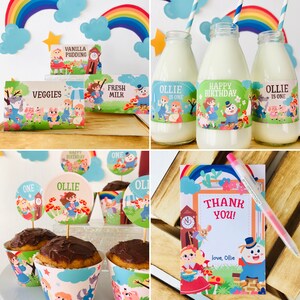 May include: A collection of party decorations featuring a whimsical storybook theme. Includes cupcake wrappers, toppers, milk bottles with labels, food labels, and a thank you card. The decorations feature illustrations of children, animals, and a rainbow.