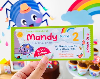 May include: A green and blue invitation card with a cartoon spider and rainbow. The text on the card reads "Come celebrate as Mandy Turns 2 Itsy Bitsy Spider 21 Oct 3-5pm 123 Henderson St City State 1234 Rsvp to: Mama Lorna 123-456-7890 Admit One".