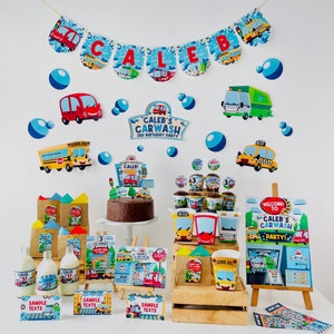 A birthday party table setting with a car wash theme. Decorations include a banner with the name "Caleb", a cake with a carwash sign, and various party favours with a carwash theme. The table is decorated with a wooden crate and a small easel with a sign that says "Welcome to Caleb's Carwash Party!"