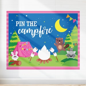 May include: A pink and blue camping themed game backdrop with the text "PIN THE campfire" and illustrations of a tent, a campfire, a beaver, a raccoon, and a rabbit.