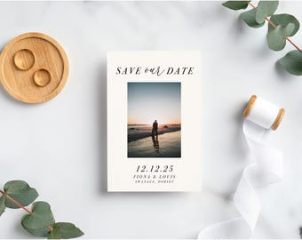 May include: Save the date card with a photo of a couple on a beach at sunset. The text reads "Save our date" and "12.12.25 Fiona & Louis Swanage, Dorset."