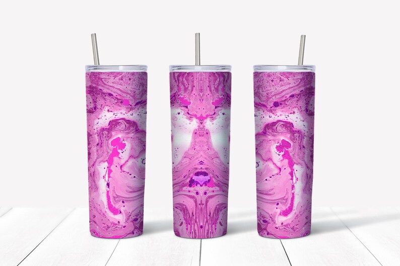 May include: Three stainless steel tumblers with pink and white marbled designs. The tumblers have lids and straws.