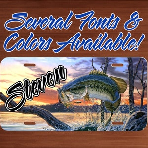 May include: Personalized license plate featuring a largemouth bass jumping out of the water with a sunset background. The name "Steven" is written in a black cursive font on the plate.