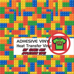 May include: A sheet of adhesive vinyl with a colorful Lego-like pattern. The text "ADHESIVE VINYL Heat Transfer Vinyl HTV COMES WITH APPLICATION TAPE!" is printed on a white banner. A red circle with a green t-shirt that says "HTV GURU" is in the corner.