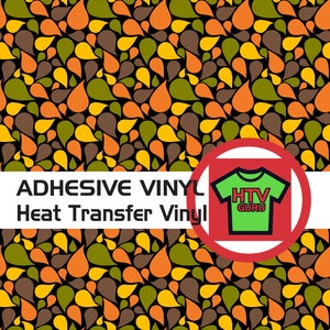 May include: A seamless pattern of teardrop shapes in shades of orange, yellow, green, and brown on a black background. The pattern is labeled "ADHESIVE VINYL Heat Transfer Vinyl" and features a green t-shirt with the text "HTV GURU" in white.