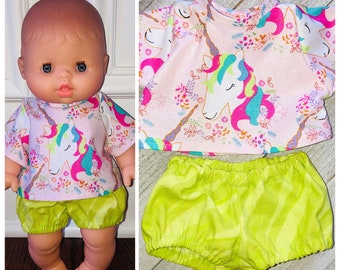 May include: A pink and green doll outfit with a unicorn print on the shirt and a lime green zebra print on the shorts.