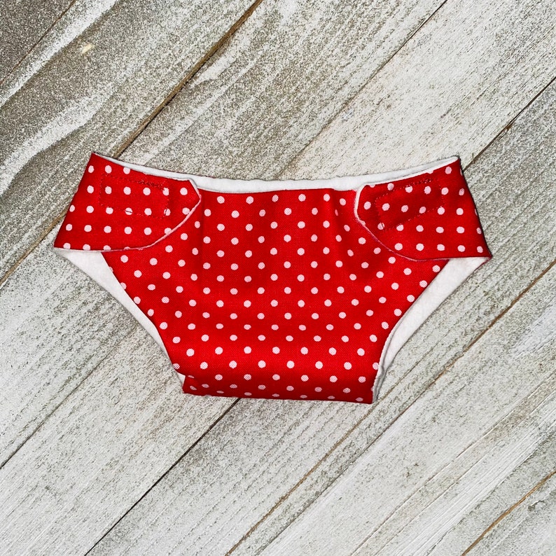 May include: Red and white polka dot diaper with white trim.