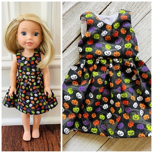 May include: A black sleeveless dress with a pumpkin pattern in orange, green, white, and purple. The dress has a gathered skirt and is perfect for a Halloween party.
