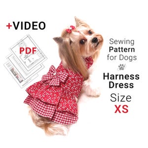May include: A small dog wearing a red and white patterned harness dress with a bow. The dress is labeled "Harness Dress Size XS" and the image includes the text "Sewing Pattern for Dogs" and "+VIDEO PDF".