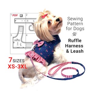 May include: A small dog wearing a blue denim ruffle harness and leash set with a cherry print. The harness has a red and white gingham ruffle trim and bow. The image also shows a sewing pattern for the harness and leash, with sizes XS-3XL.