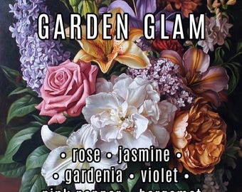 May include: A bouquet of flowers with a variety of colors and textures, including pink roses, white peonies, purple lilacs, and orange lilies. The text "GARDEN GLAM" is written in black letters across the top of the image. Below the flowers, the text "rose, jasmine, gardenia, violet, pink pepper, bergamot" is written in black letters.