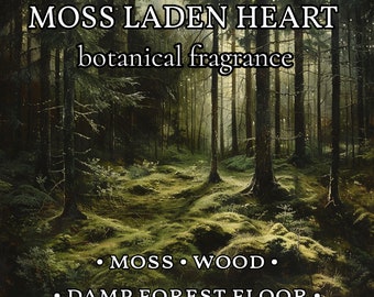 May include: A botanical fragrance label titled MOSS LADEN HEART with the text MOSS, WOOD, DAMP FOREST FLOOR. The background features a dark, dense forest with tall trees and a mossy green floor illuminated by soft, dappled sunlight filtering through.