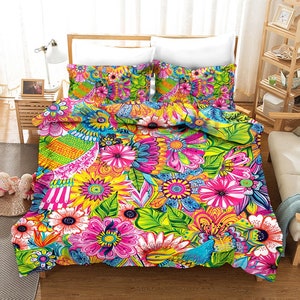 May include: A colorful floral duvet cover with a bright green background and pink, yellow, and blue flowers. The duvet cover features a whimsical design with birds and leaves.