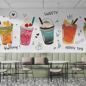 May include: A wall mural featuring cartoon illustrations of five colorful beverages in clear cups with straws. The words "Yummy!", "Sweety", and "Happy Time" are written on the wall. Below, there are tables and chairs.