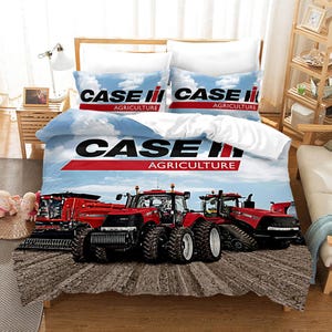 May include: A white and blue bedding set featuring a red Case IH logo and images of red tractors. The set includes a duvet cover, two pillowcases, and a flat sheet.