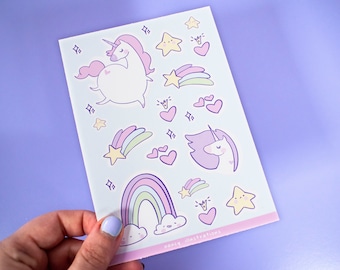 May include: A sheet of pastel-colored unicorn and rainbow stickers. The stickers feature a white unicorn with a pink mane and tail, a rainbow with clouds, a yellow star, and pink hearts. The sheet is labeled "meery illustrations".