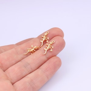 May include: Three gold-colored lizard charms with a loop for attaching to jewelry or other crafts.