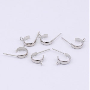 May include: Silver-toned earring findings with a loop on one end and a post on the other. The findings are designed to be used with a variety of earring styles.