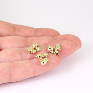 2/4 x 小さなリボン結びチャーム、金メッキ真鍮製、10 mm x 10 mm、ジャンプリング付き、Jewellery Making Supplies London (JMSLondonCo) 製