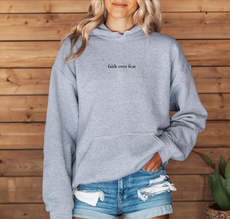 May include: A gray hooded sweatshirt with the text "faith over fear" printed on the front.