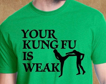 May include: Green t-shirt with black text that reads "Your Kung Fu Is Weak" and a graphic of two figures in a martial arts pose.