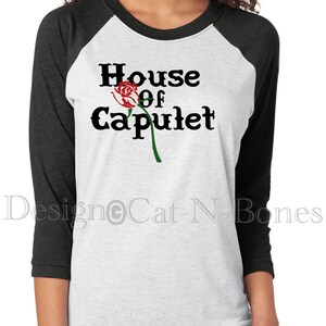 May include: A white and black baseball tee shirt with the text "House of Capulet" and a red rose graphic.