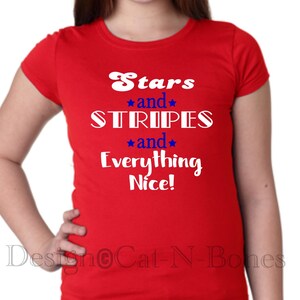 May include: Red t-shirt with white text that reads "Stars and Stripes and Everything Nice!"